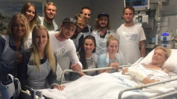 Friends visit Brett Connellan's bedside in hospital.