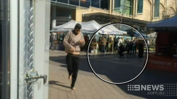 Alleged knife attacker Jerry Sourian at Westfield Hornsby with an injured bystander in the background.