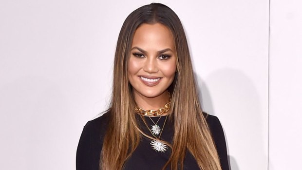 Chrissy Teigen is sorry for showing you her 'hooha' in pelvic bone baring dress at the AMAs on Sunday.