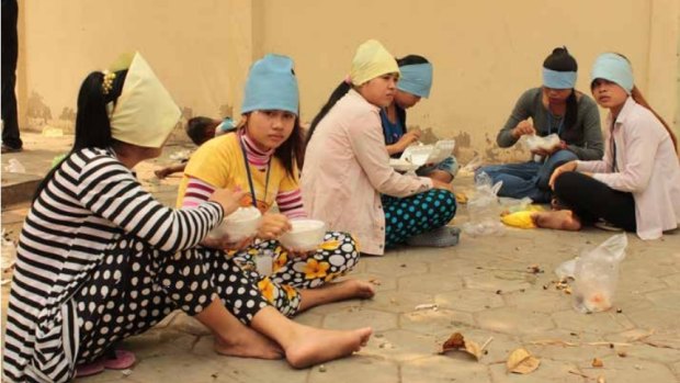 Garment factory workers in Cambodia during their lunch break.