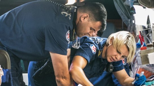 Paramedics work to revive the 49-year-old man who suffered a cardiac arrest at Bondi Junction.