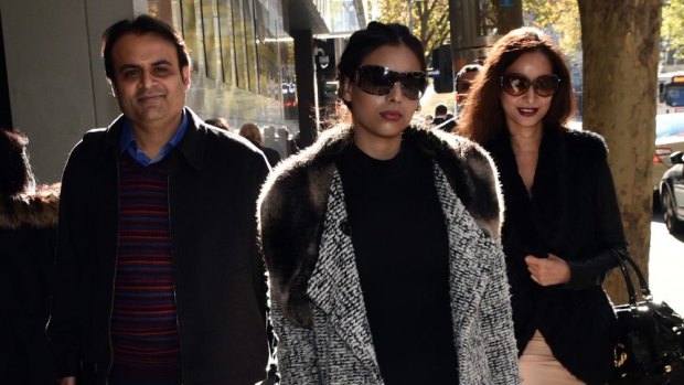 Pankaj Oswal (left) and his wife Radhika (right) and daughter Vasundhara leave court in Melbourne: There is little doubt it was the bank that blinked first.