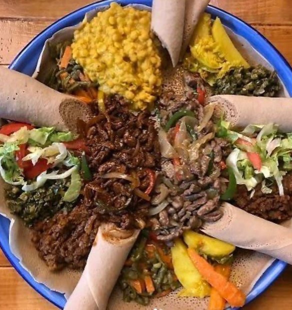 A platter of meat and dishes with injera bread from Sara's Ethiopian Cuisine in Wollongong.