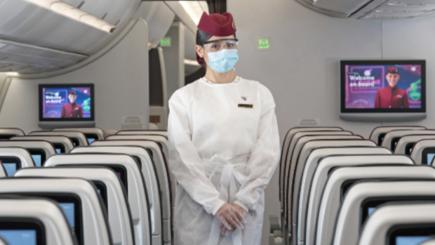A cabin crew member wears the shield and mask, in addition to a new protective gown.

 