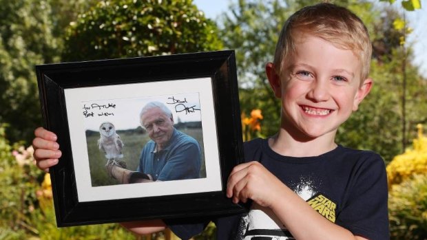 Super smiler: Archie Comerford, 6, with his personally signed photograph from Sir David Attenborough.