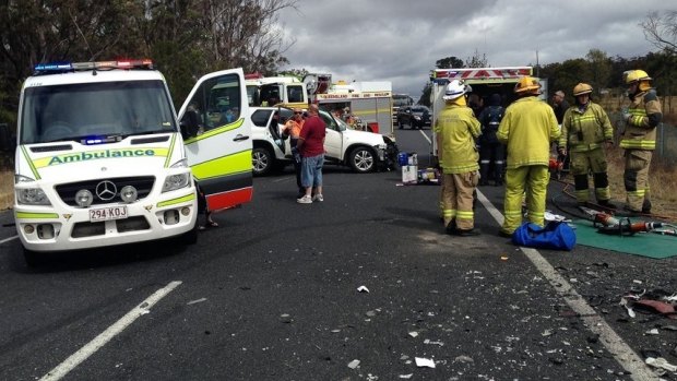 Emergency personnel attend the scene of the head-on crash at Dalveen.
