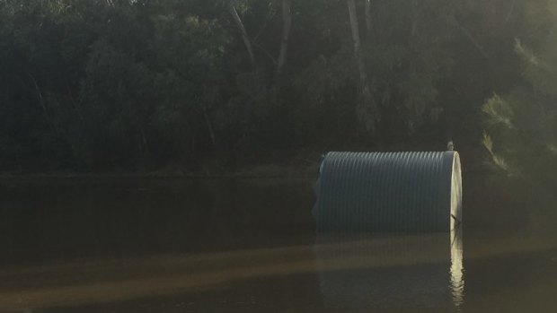 One of two AGL tanks dislodged by the flooded Nepean River.