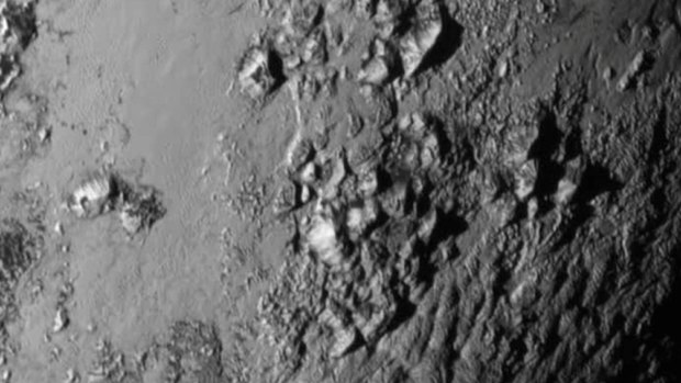 Icy mountains are revealed for the first time on Pluto in the first high-resolution photo sent back from the New Horizons probe.