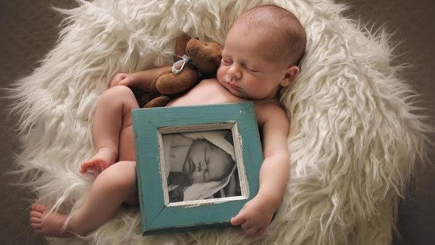 Isobel Carroll with a framed photo of her brother Samuel, who died before she was born. 