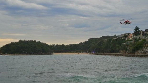 A helicopter circles Shelly Beach, Manly, in search of a suspected second diver. It was later confirmed there was only one diver.