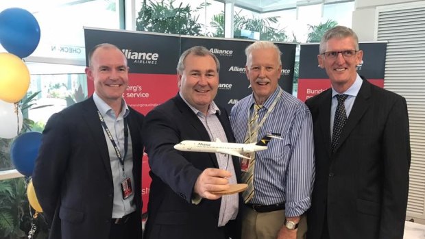 Alliance Airlines lands in Bundaberg - with CEO Lee Schofield (far left) greeted by Bundaberg Mayor Jack Dempsey (second from left).