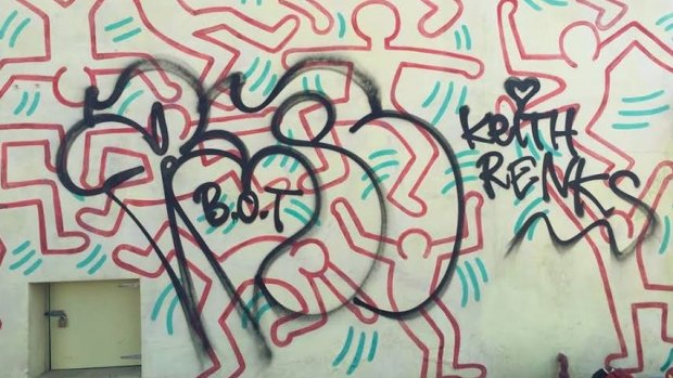 The current graffiti on Keith Haring's mural.