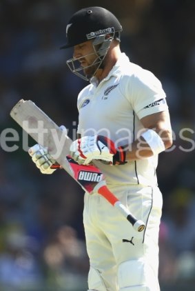 Brendon McCullum assesses the damage to his bat.