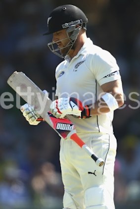 Brendon McCullum assesses the damage to his bat.