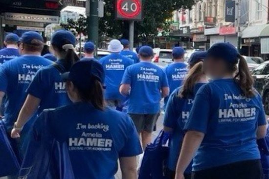 Brethren members, wearing clothes to make them unrecognisable, supporting the Liberal candidate head to a polling booth in Kooyong.