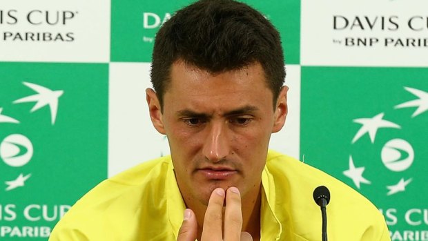 Plenty to ponder: Lleyton Hewitt and Bernard Tomic face the media after Australia's loss to the United States.
