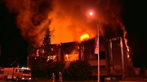 Firefighters battle a blaze at the abandoned Oak building on the Gold Coast early Sunday.