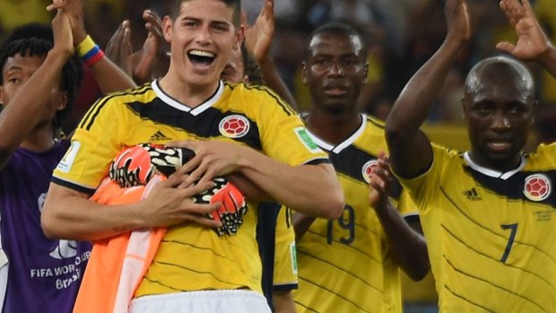Colombia's outstanding midfielder James Rodriguez and his teammates celebrate after defeating Uruguay 2-0 at the Maracana Stadium.