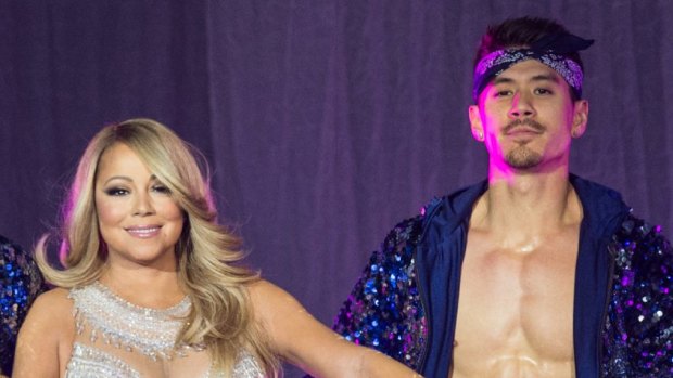Mariah Carey on stage in London in March with back-up dancer Bryan Tanaka.