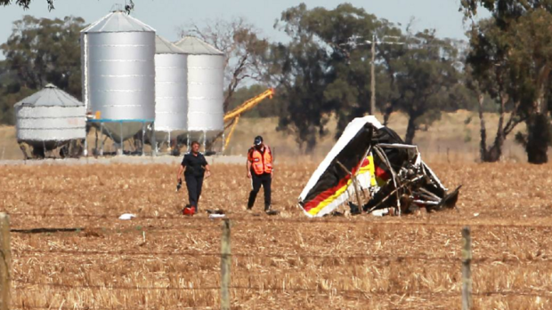 Investigators inspect the damaged aircraft in a field at Yarrawonga on Monday morning.