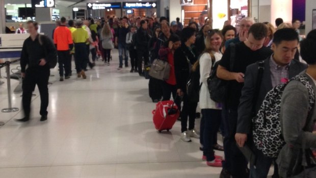 Passengers queue at Sydney International Airport for security checks on Monday.