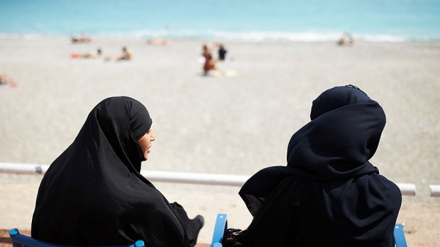 Two Muslim women soak up the sun in Nice.