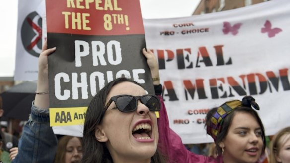 Demonstrators take part in a protest to urge the Irish Government to repeal the 8th amendment to the constitution, which enforces strict limitations to a woman's right to an abortion, in Dublin.