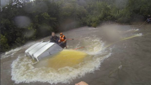 Three people plucked from their car after becoming stuck in floodwaters at Moruya.