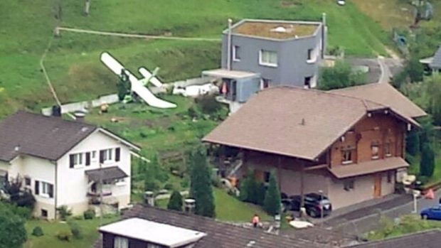 One of two planes which crashed during an air show is seen in the village of Dittingen, Switzerland.