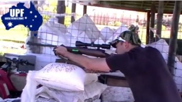 A still from a video showing former UPF organiser Shermon Burgess shooting a rifle.  