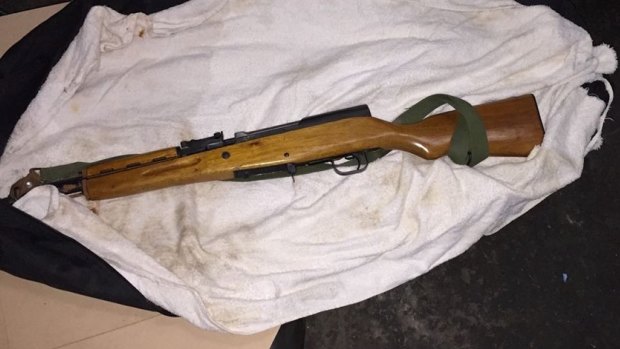 A gun seized by police during property raids.