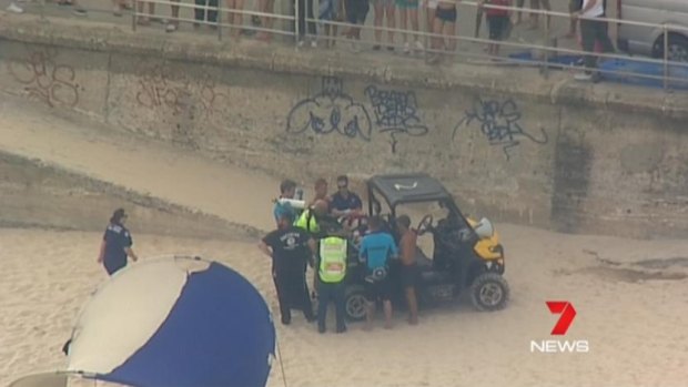 Paramedics and lifeguards treated the man before he was taken to an ambulance.