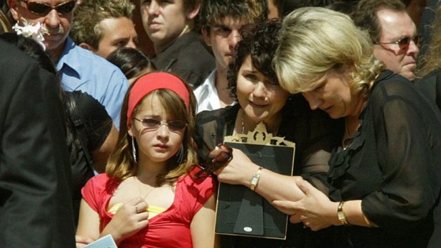 Monica-Rose Weight, then 11, pictured with her mother, Jennie-May Weight, at the funeral for her sister, Stevie-Lee, in Mildura in 2006.