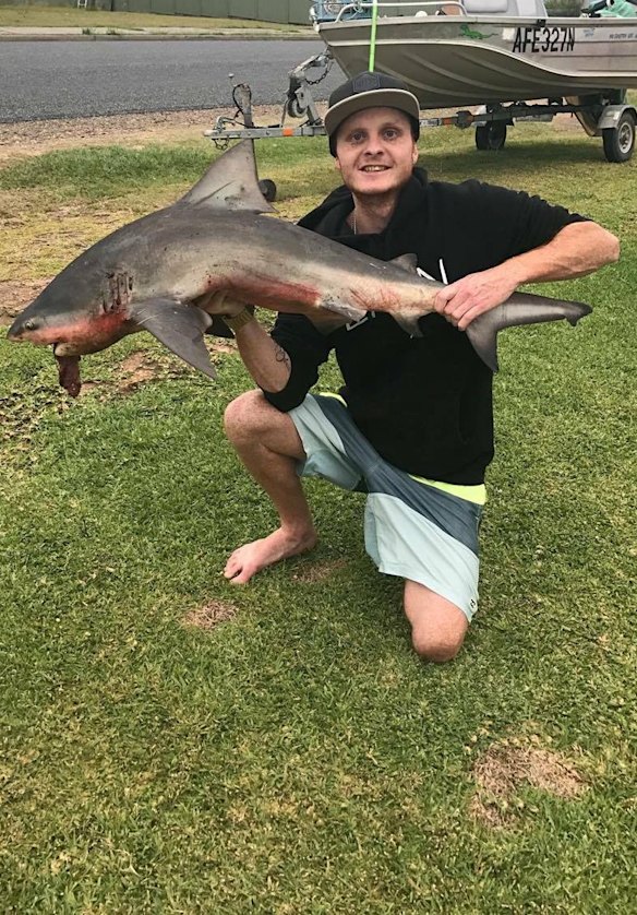 Jamie Leeder with a 1.5m juvenile bull shark.