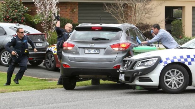 Police desperately try to smash the windows of the allegedly stolen car after their vehicles were rammed.