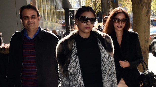 Pankaj Oswal (left) and his wife Radhika (right) and daughter Vasundhara leave court in Melbourne in May.
