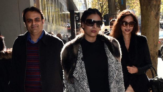 Pankaj Oswal (left) and his wife Radhika (right) and daughter leave court in Melbourne.