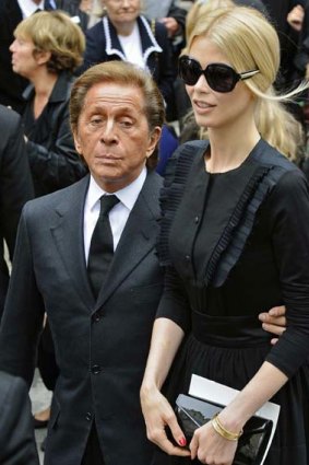 Italian designer Christian Valentino (L) and German model Claudia Schiffer attend the funeral service for late fashion designer Yves Saint Laurent in Paris June 5, 2008.  