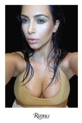 Kim Kardashian has revealed the cover of her selfie book. 