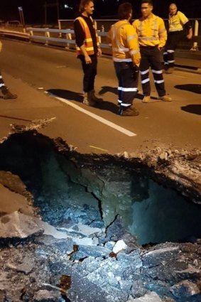Early indications suggested the sinkhole was caused by water from Downfall Creek undermining the road.
