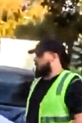 A frame from video footage apparently showing a man telling teenagers to take an Israeli flag off their car.