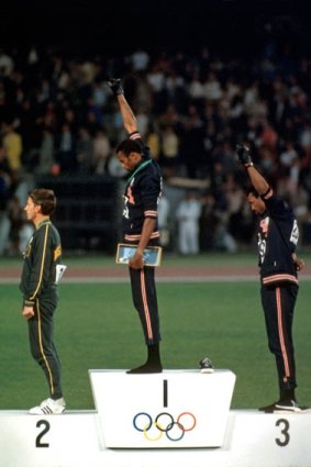 Australia's Peter Norman on the medal dais at the 1968 Olympics in Mexico City as US athletes Tommie Smith  and John Carlos give the Black Power salute.