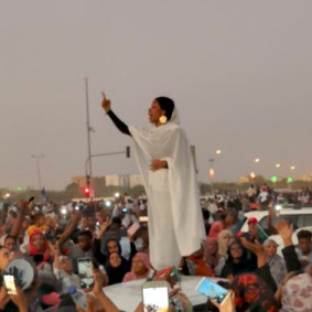 Alaa Salah singing traditional songs to protesters in Sudan in a photo by activist Lana Haroun.