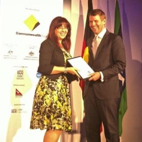 Eman Sharobeem receives her commendation in the Australian of the Year Award from then-NSW premier Mike Baird.