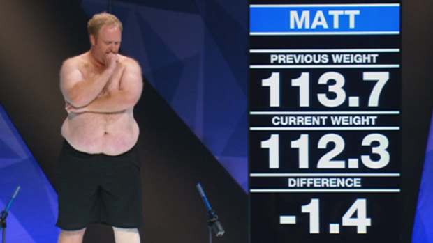 Contestant Matt, from the 2014 season of <i>The Biggest Loser</i>, next to the giant screen used in studio weigh-ins.