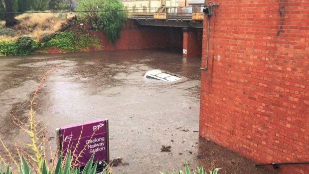 This car was underwater at Geelong train station after it was hit with heavy rain on Wednesday.