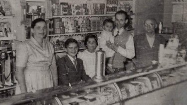 George Poulos with his family behind the counter of The Rio in its golden years. From left, Stavroula, Nik, Aphrodite, George holding Margaret and George's father, Philip. "We used to open until 11 o'clock waiting for the picture show to come out," says Nik Poulos.