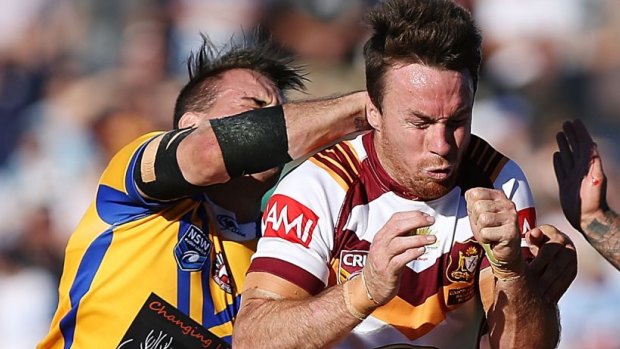 Collared: Josh Reynolds of City tries to drag James Maloney of Country to the ground. 