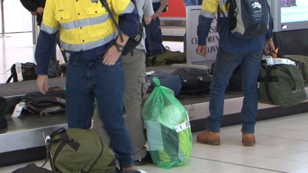 Cloudbreak mine site workers arrive back in Perth on Wednesday.