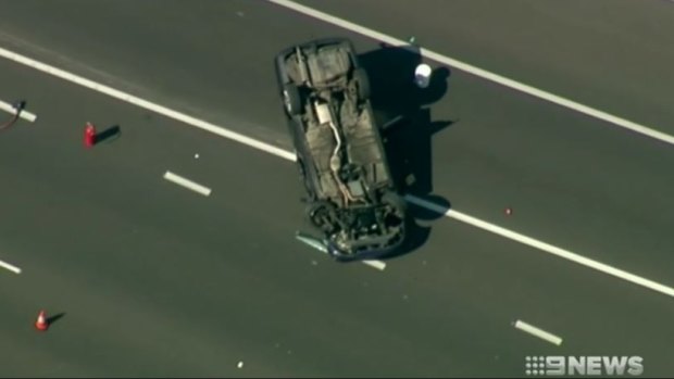 The Holden Commodore flipped and landed on its roof on the freeway.
